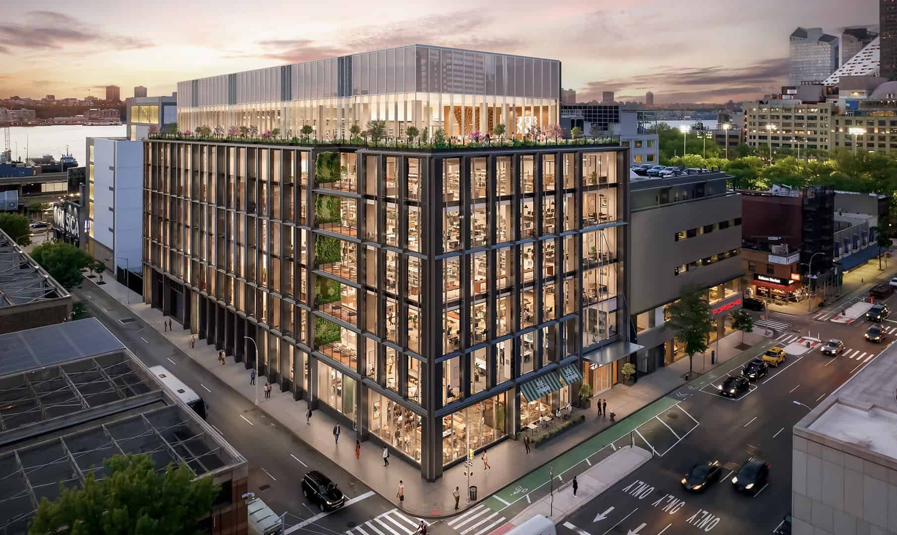 7-story commercial building on street corner at dusk